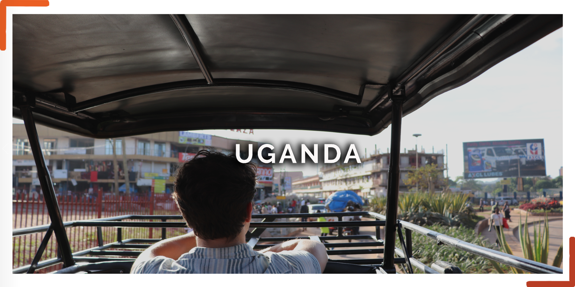Man driving a car through the streets of Kampala